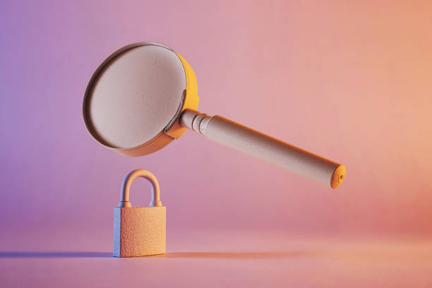 istock Close-up of a magnifying glass floating above a padlock 1360381853