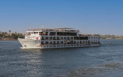 Large luxury traditional Egyptian river cruise boat sailing on the Nile