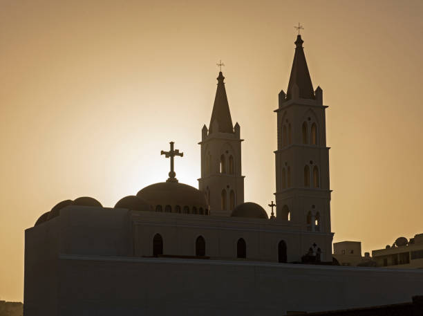 Large Coptic Christian church with sunset orange sky stock photo
