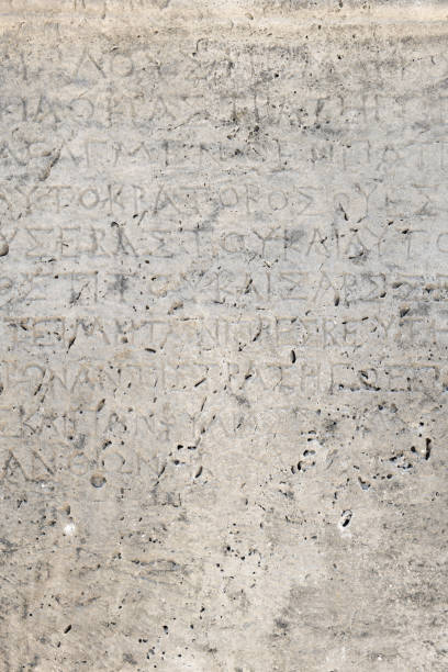 istock Ancient Greek inscriptions on stone in archeological ruin in ancient Greece site - design, background, texture 1360384708