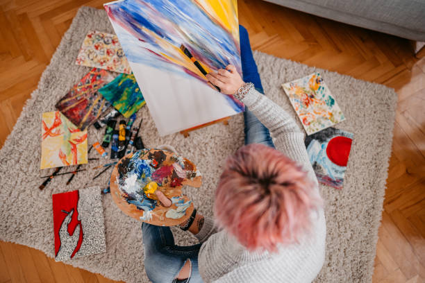 istock Young Female Artist Panting At Home 1360387343