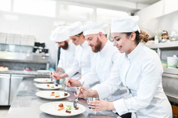istock Cooking Competition Ending With Special Topping Put By Smiling Cooks On Dinner 1360387955