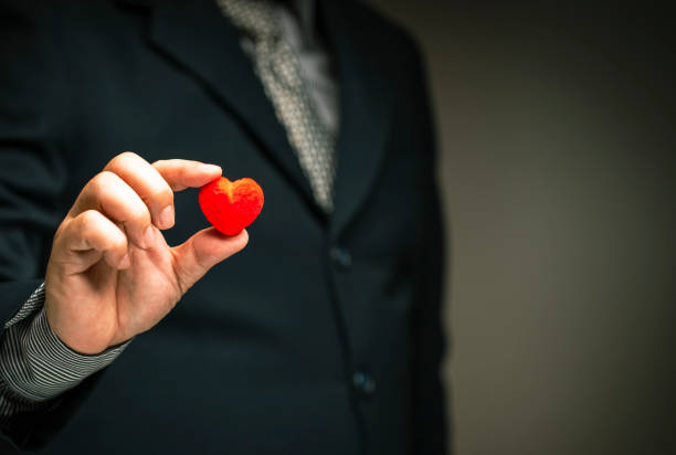 istock Service satisfaction concept, rated positive satisfaction.business man give Highest service ratings with red heart. 1360388003
