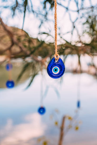 Evil Eye Beads Hanging From a Tree on the Beach
