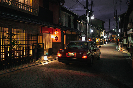 Taxi in the streets of Kyoto at night, typical japanese taxi.