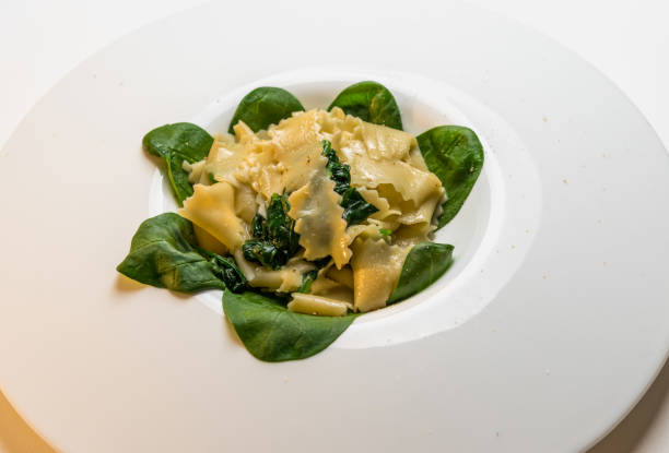 Pasta Maltagliati Pasta Maltagliati with spinach and  butter sauce, close up in white dish spinach pasta stock pictures, royalty-free photos & images