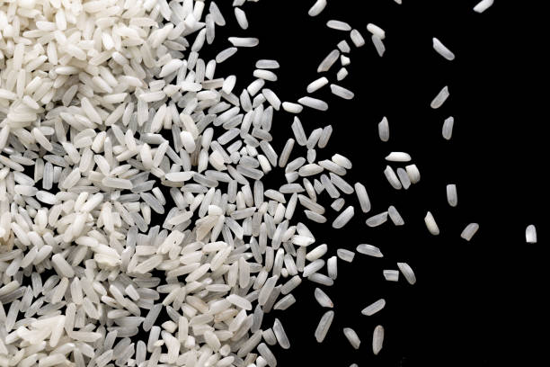 istock white rice on a black isolated background 1360395167