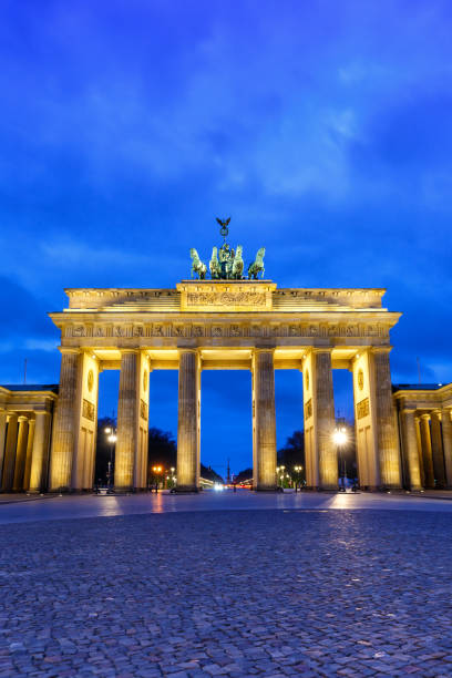 istock Berlin Brandenburger Tor Gate in Germany at night blue hour copyspace copy space portrait format 1360396588