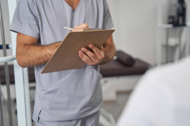 istock Doctor standing before his patient during medical consultation 1360396871