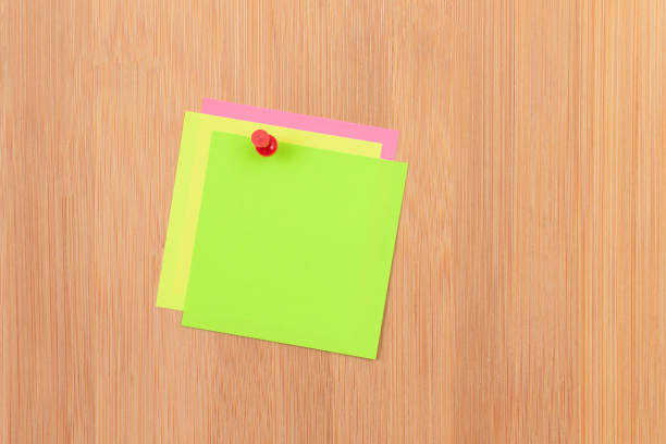 istock Colored Sticky Notes Pinned to the Wooden Message Board 1360401233