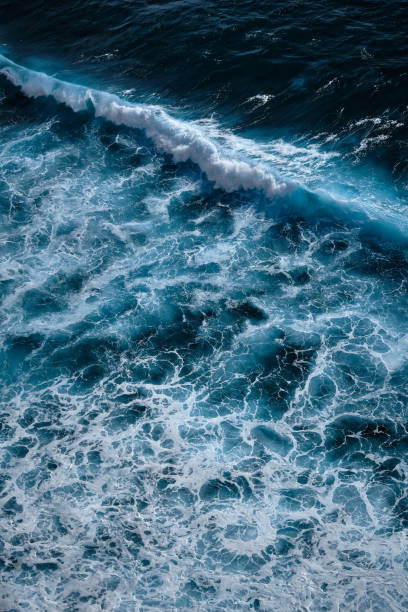 istock Aerial view to seething waves with foam. 1360401511