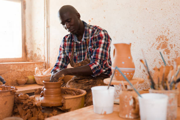 istock Man making ceramics on pottery wheel 1360402027