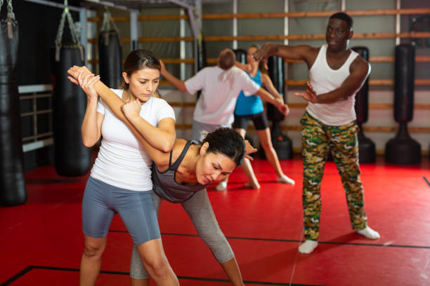 istock Womens sparring in self defense courses in gym 1360402982
