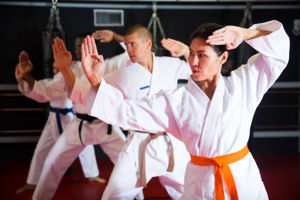 istock Men and women in kimono performing kata 1360403113