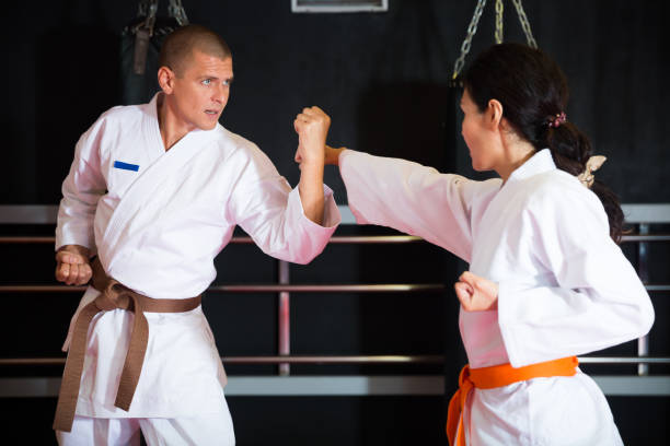 istock Man and woman sparring during karate training 1360403150