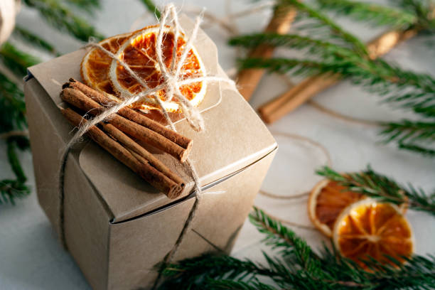 istock Christmas gift paper box decorated with dry oranges and cinnamon 1360403974