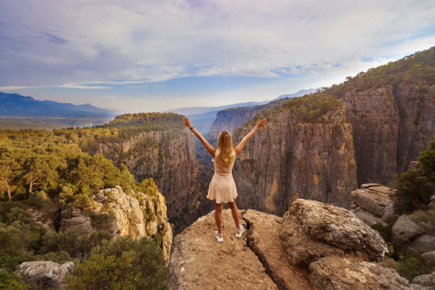 Tourist Woman on the edge of a cliff of Tazi Canyon in Manavgat, Antalya, Turkey. Greyhound Canyon, Wisdom Valley stock photo