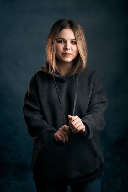 istock Woman portrait studio shot on blue background 1360405768