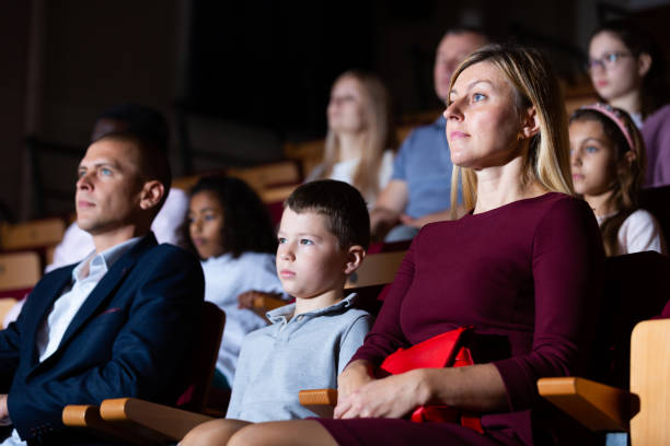 istock Parents with tween son watching theatrical performance in theater 1360406766