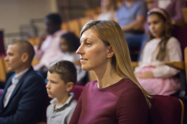 istock Woman watching theatrical performance in theater hall 1360406776