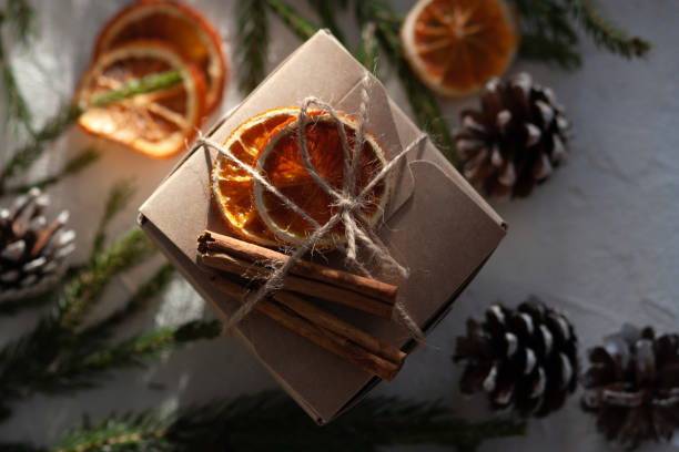istock Christmas gift paper box decorated with dry oranges and cinnamon 1360415559