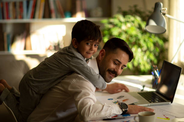 istock An working from home with laptop during quarantine. Home office and parenthood at same time. Exhausted parent with hyperactive child. 1360416710