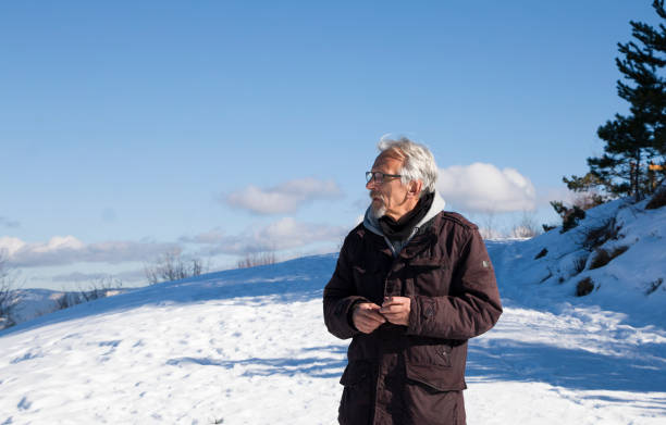 istock Elder man enjoying the fresh air on the mountain. 1360417801