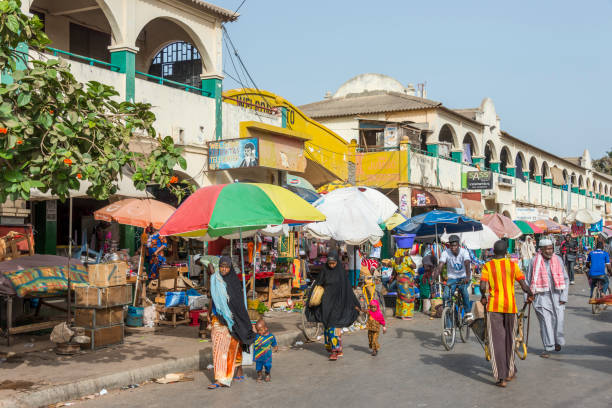 Banjul, The Gambia - May 09, 2017: Street and shops outside the Albert Market in the historic city center