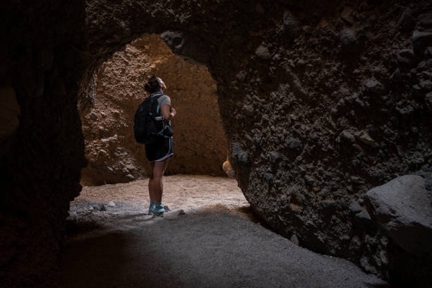 istock Woman Finds Cavern in Sidewinder Canyon 1360424780