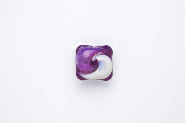 2 in 1 detergent pod A picture of 3 in 1 laundry detergent pod on isolated white background. Economic and environment friendly for clothes washing detergent capsule stock pictures, royalty-free photos & images