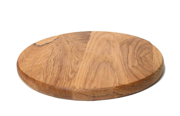 istock empty round wooden kitchen cutting board, pizza stand. White background 1360428670