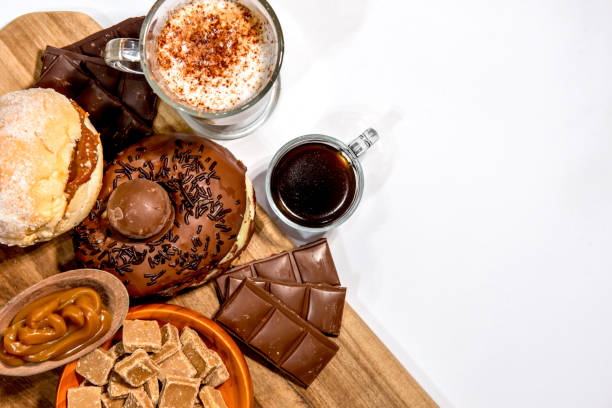 istock Wooden board with donuts, chocolate, coffee and moccha. Top view. 1360431377