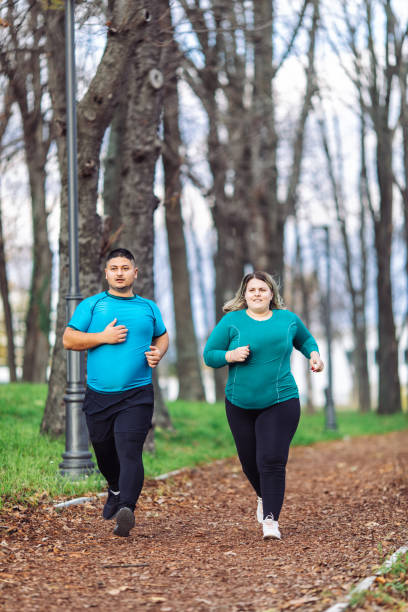 istock People with overweight problem running in city park 1360433415