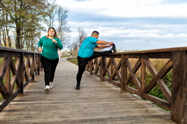 istock People with overweight problem exercising in city park 1360434189