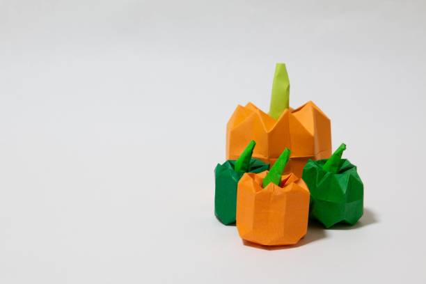 istock Pumpkin made of origami placed on a white background 1360436633