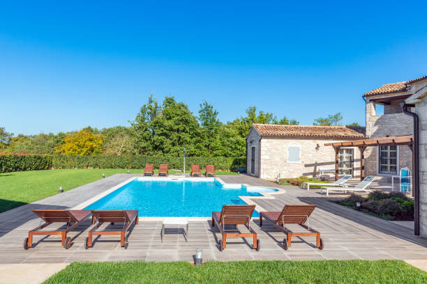 istock Luxurious beautiful modern villa with swimming pool and yard garden 1360436823