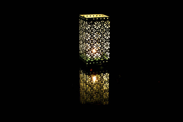 istock Festive lantern with burning candle on dark background 1360437594