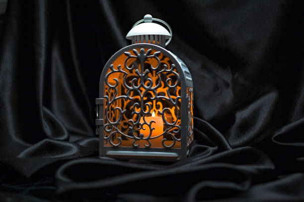 istock Festive lantern with burning candle on dark background 1360437608