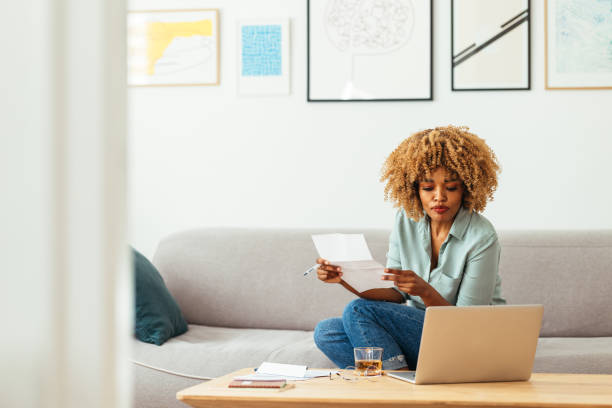 istock Home Office: An Afro-American Woman Looking at a Laptop 1360438521