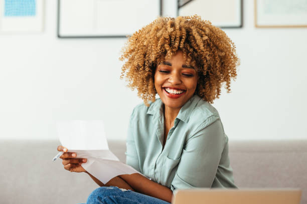 istock Home Office: An Afro-American Woman Looking at a Laptop 1360438524