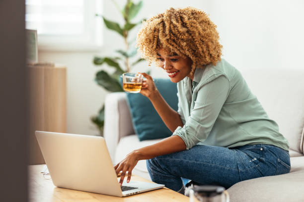 istock Home Office: An Afro-American Woman Looking at a Laptop 1360438533