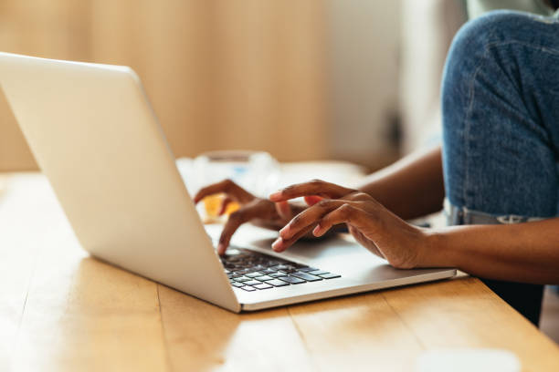istock Home Office: Anonymous Afro-American Woman Typing on a Laptop 1360438542