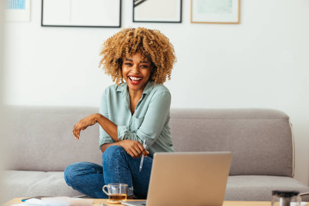 istock Home Office: An Afro-American Woman Looking at a Camera 1360438559