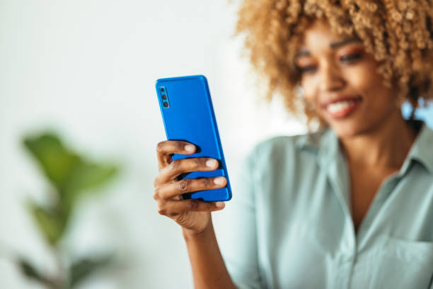 istock Afro-American Woman Using a Smartphone 1360438600