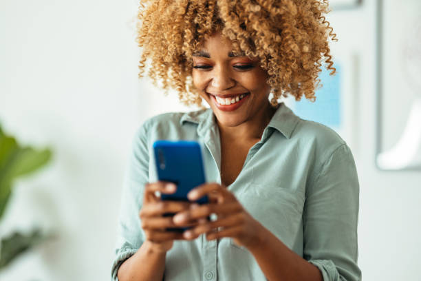 istock Afro-American Woman Using a Smartphone 1360438604