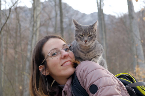 istock Active young woman portrait and her cat in the forest 1360446776