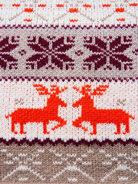 istock Jacquard knitted pattern. Geometric ornament for Christmas or New Year. Two red deer on a white knitted background, snowflakes, stripes. Winter fashionable modern animal traditional folk ornament 1360448611