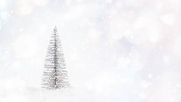 istock New Year concept.Background for congratulations.Simple minimalistic.Decorative silver Christmas tree on light background.New Year's card background.Copy space. 1360448655