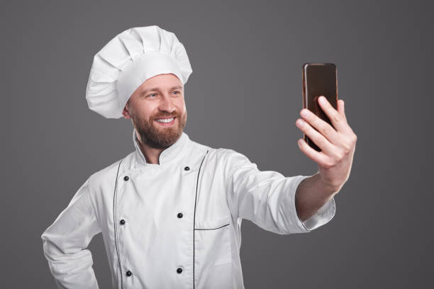 istock Cheerful male cook taking selfie 1360448700
