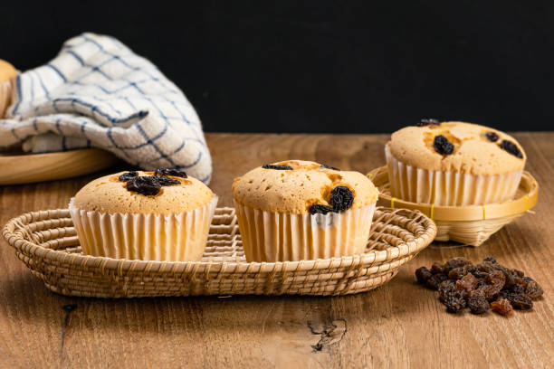 istock Homemade raisin sponge cupcake in bamboo basket. 1360452717